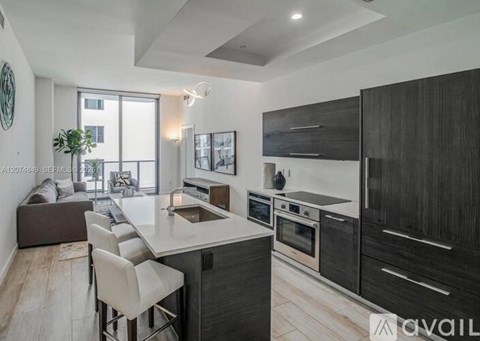 A modern kitchen with dark wood cabinets and white countertops.