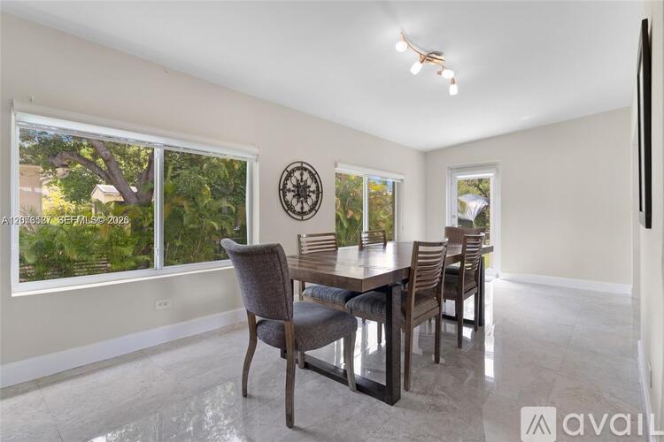 A dining room with a table set for four.
