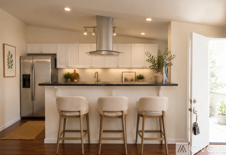 A kitchen with white cabinets and a stainless steel refrigerator.