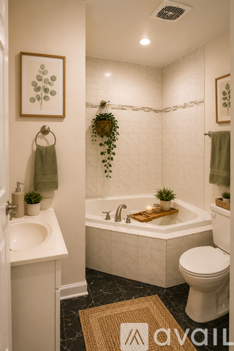A bathroom with a white tub, toilet, and sink.
