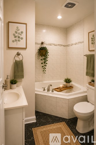 A bathroom with a white tub, toilet, and sink.