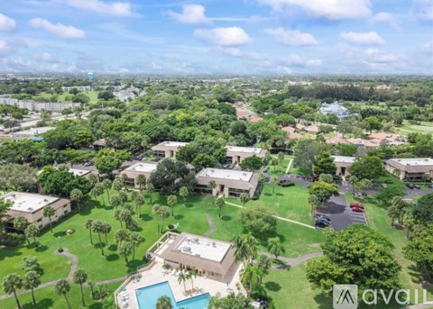 A bird's eye view of a residential area with a swimming pool.