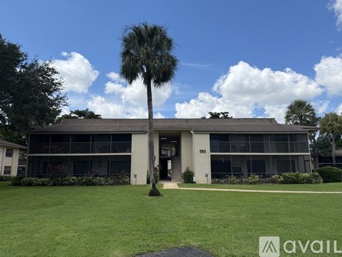 A building with a palm tree in front of it.
