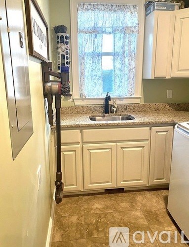 A kitchen with a sink and a window.