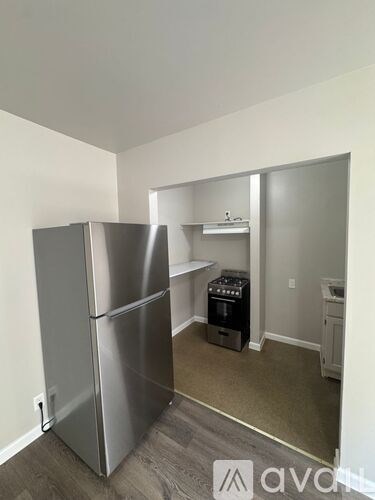A kitchen area with a refrigerator, oven, and dishwasher.