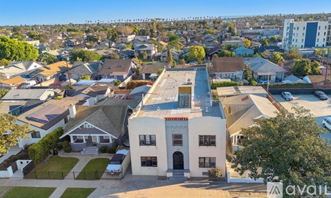 A bird's eye view of a residential area with a white house in the foreground.
