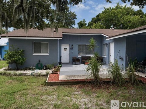 A house with a blue front yard and a porch.