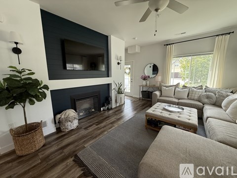 A living room with a fireplace and a television on the wall.
