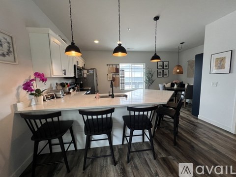 A kitchen with a table and chairs.