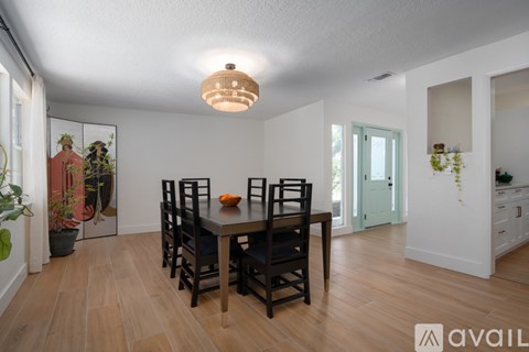A dining room with a table and chairs.
