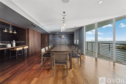 A modern dining room with a wooden table and chairs.