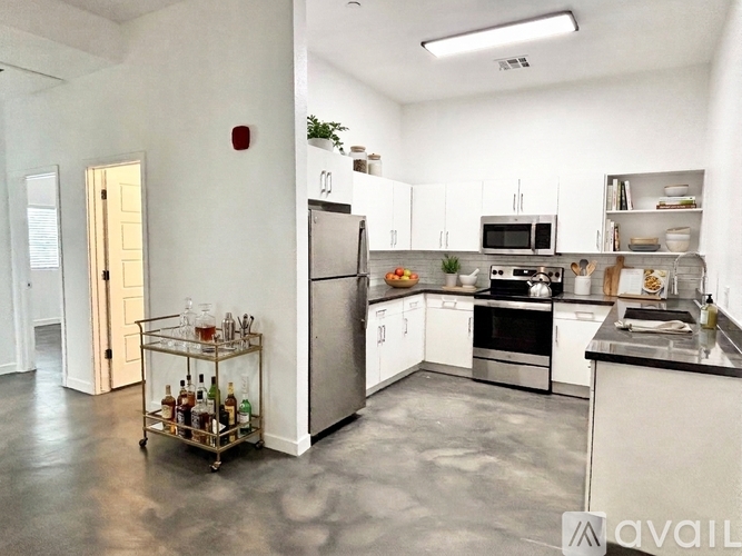 A kitchen with white cabinets and stainless steel appliances.