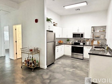 A kitchen with white cabinets and stainless steel appliances.