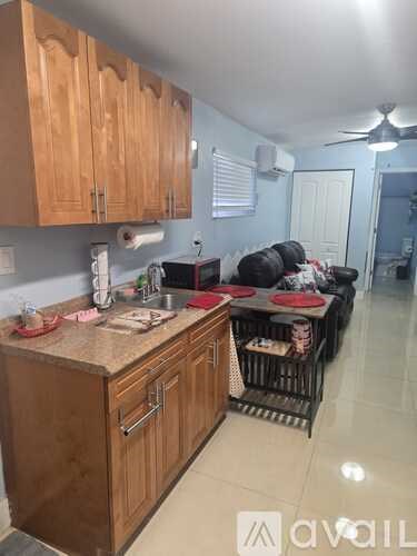 A kitchen with wooden cabinets and a countertop.