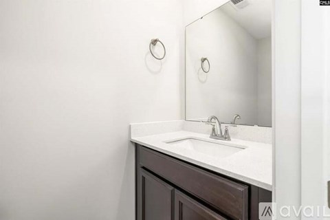 A bathroom sink with a mirror above it.