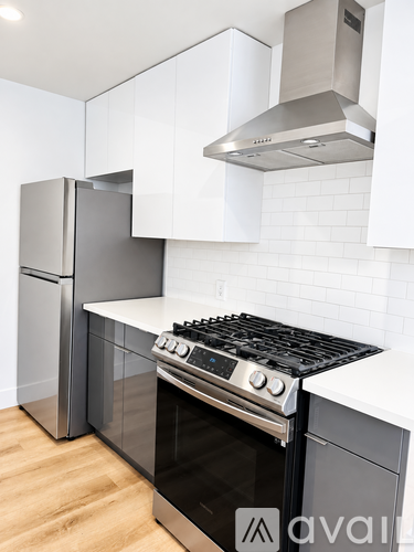 A modern kitchen with a stove, oven, and refrigerator.
