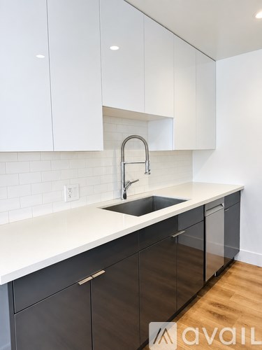 A kitchen with white cabinets and a sink.