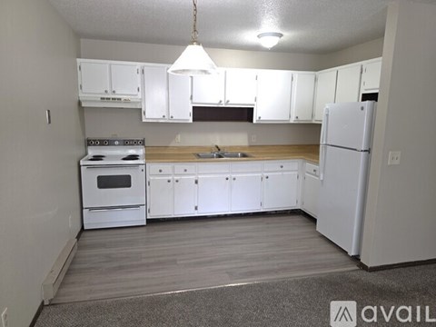 A kitchen with white appliances and cabinets.