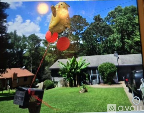 A yellow kite with red circles is flying in the sky.