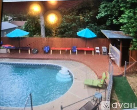 A pool with a waterfall and a hot tub.