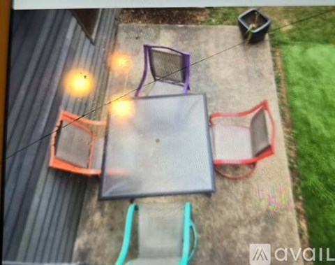 A backyard with a basketball hoop and a trampoline.