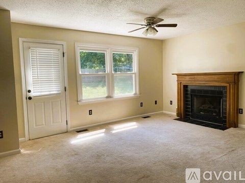A room with a fireplace and a window with blinds.