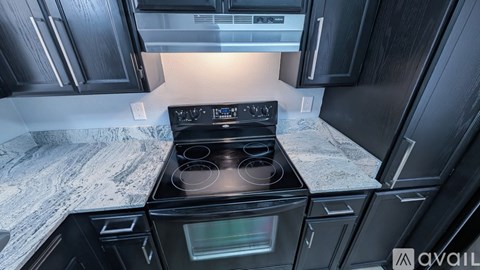 A modern kitchen with a black stove top oven.
