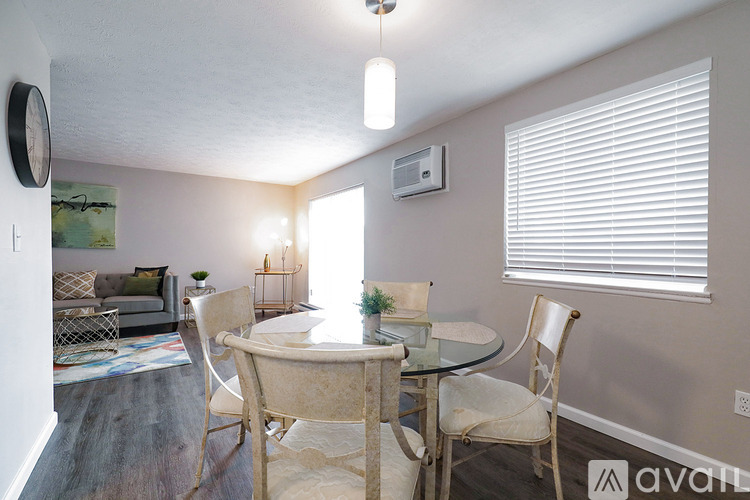 A dining room with a glass table and chairs.