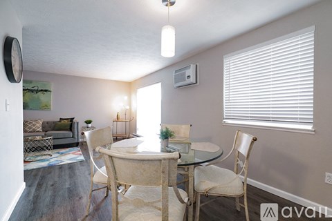 A dining room with a glass table and chairs.