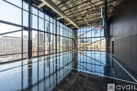 A spacious room with large windows overlooking a cityscape.