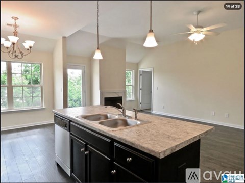 A kitchen with a sink and a window.