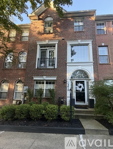 A brick building with a black door and windows.