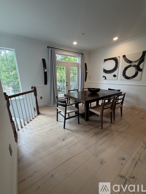 A dining room with a wooden table and chairs.
