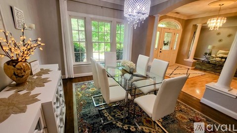 A dining room with a glass table and chairs.