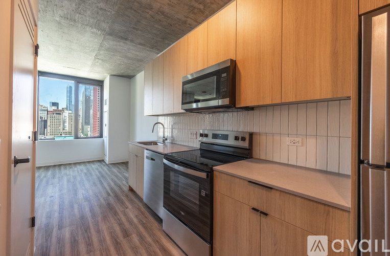 A kitchen with wooden cabinets and a stainless steel oven.