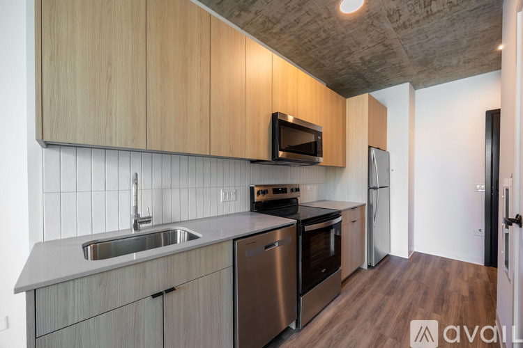 A kitchen with wooden cabinets and stainless steel appliances.