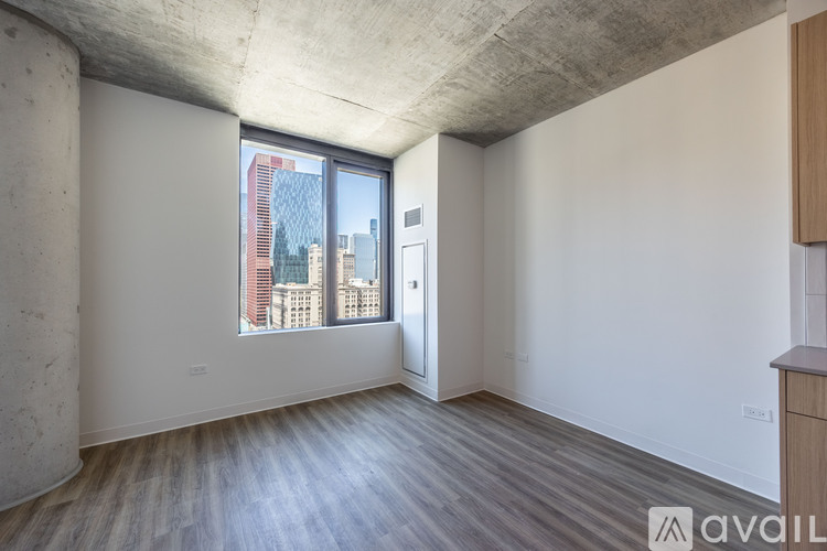 A room with a large window and a view of a city skyline.