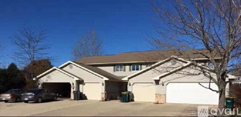 A house with a brown roof and a white garage door.