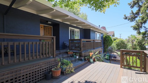 A house with a blue exterior and a wooden deck.