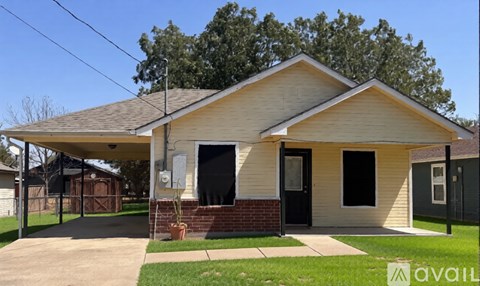 A house with a covered front porch and a brick pillar.