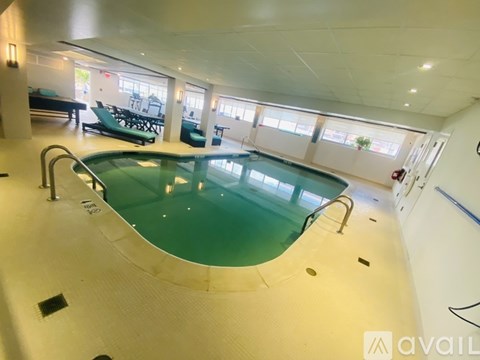 A large indoor swimming pool with a glass bottom.