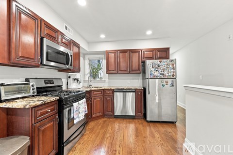 A kitchen with wooden cabinets and a refrigerator covered in magnets.