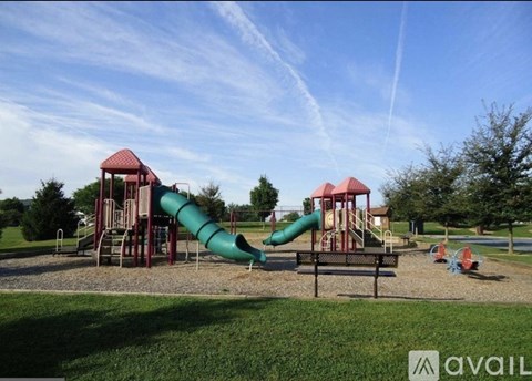 A playground with a green and red slide.