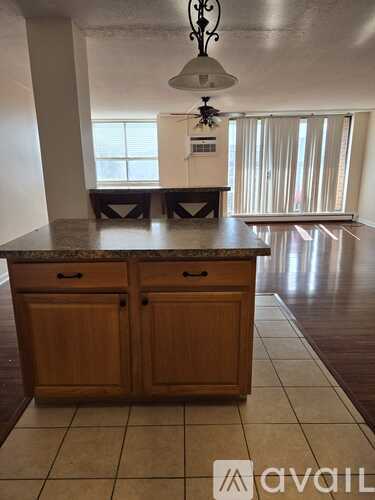 A kitchen with wooden cabinets and a granite countertop.