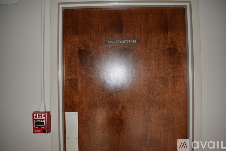 A wooden door with a sign that says laundry/storage.