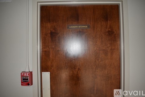 A wooden door with a sign that says laundry/storage.