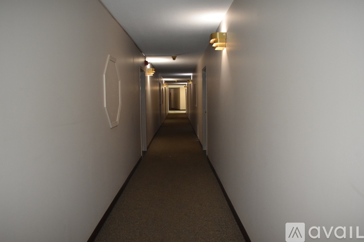 A long hallway with lights on the ceiling and walls.
