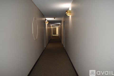 A long hallway with lights on the ceiling and walls.