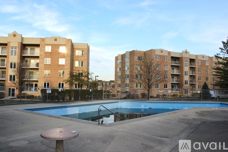 A large swimming pool in front of apartment buildings.