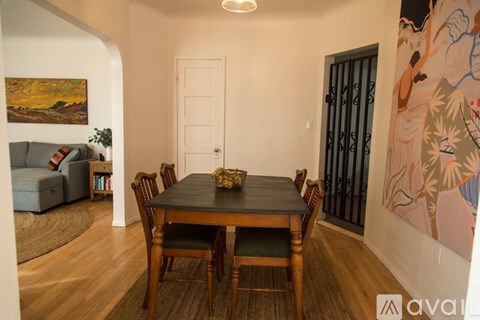 A dining room with a wooden table and chairs.